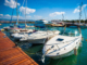 Multiple boats moored to jetty in daylight